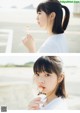 A young woman holding a lollipop in her hand.