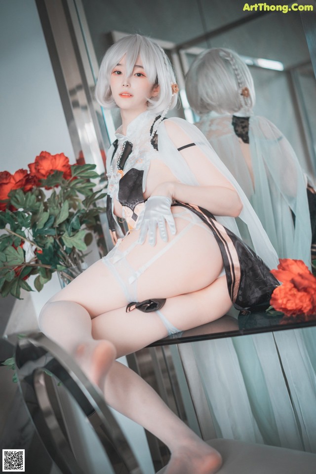 A woman sitting on top of a table next to a mirror.
