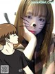 A girl with a cat face painted on her face.