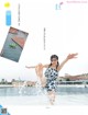 A woman in a bathing suit is splashing in the water.