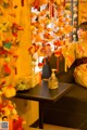 A woman in a kimono sitting on a couch in a room.